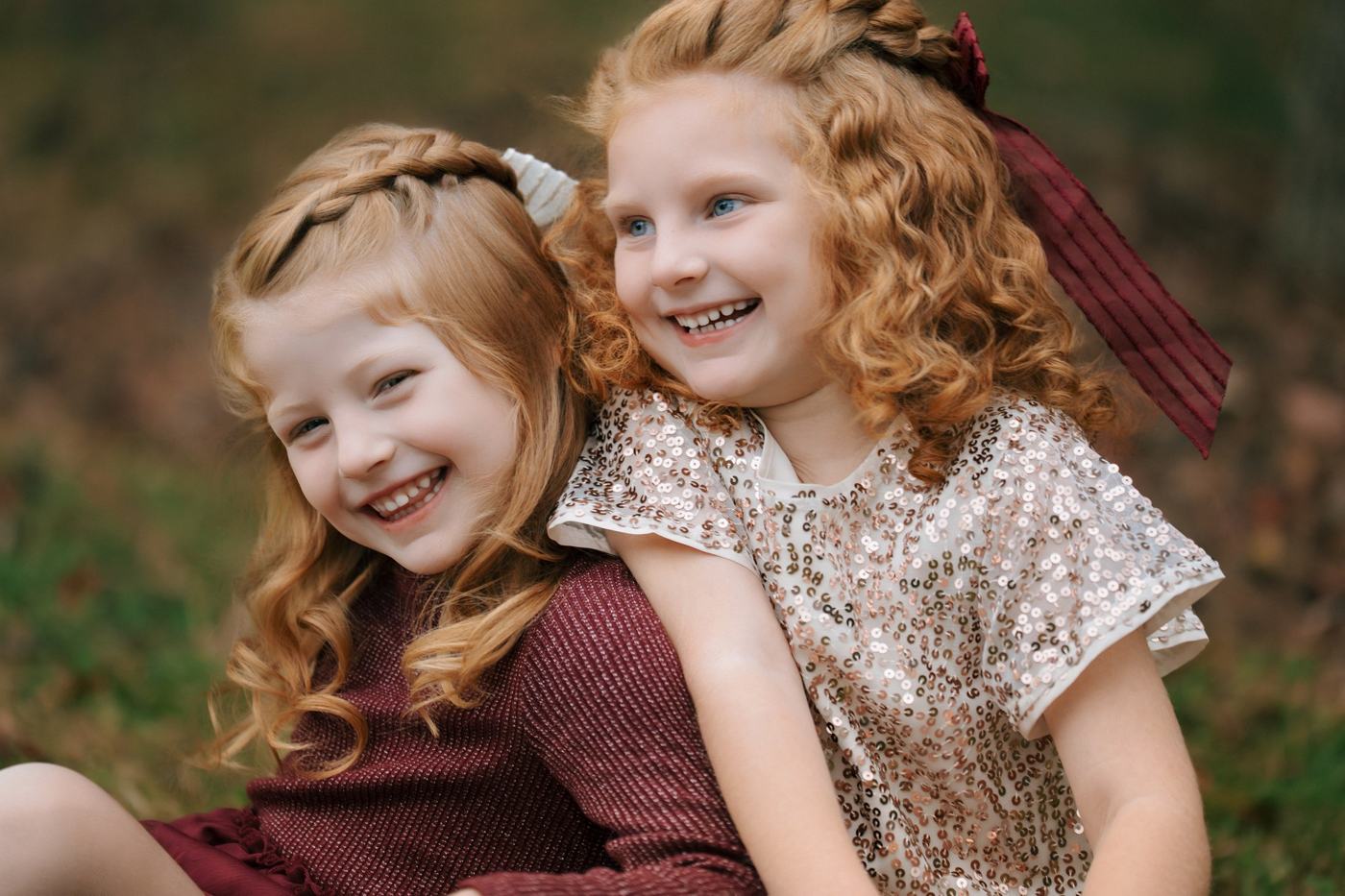 Two children laughing together outdoors